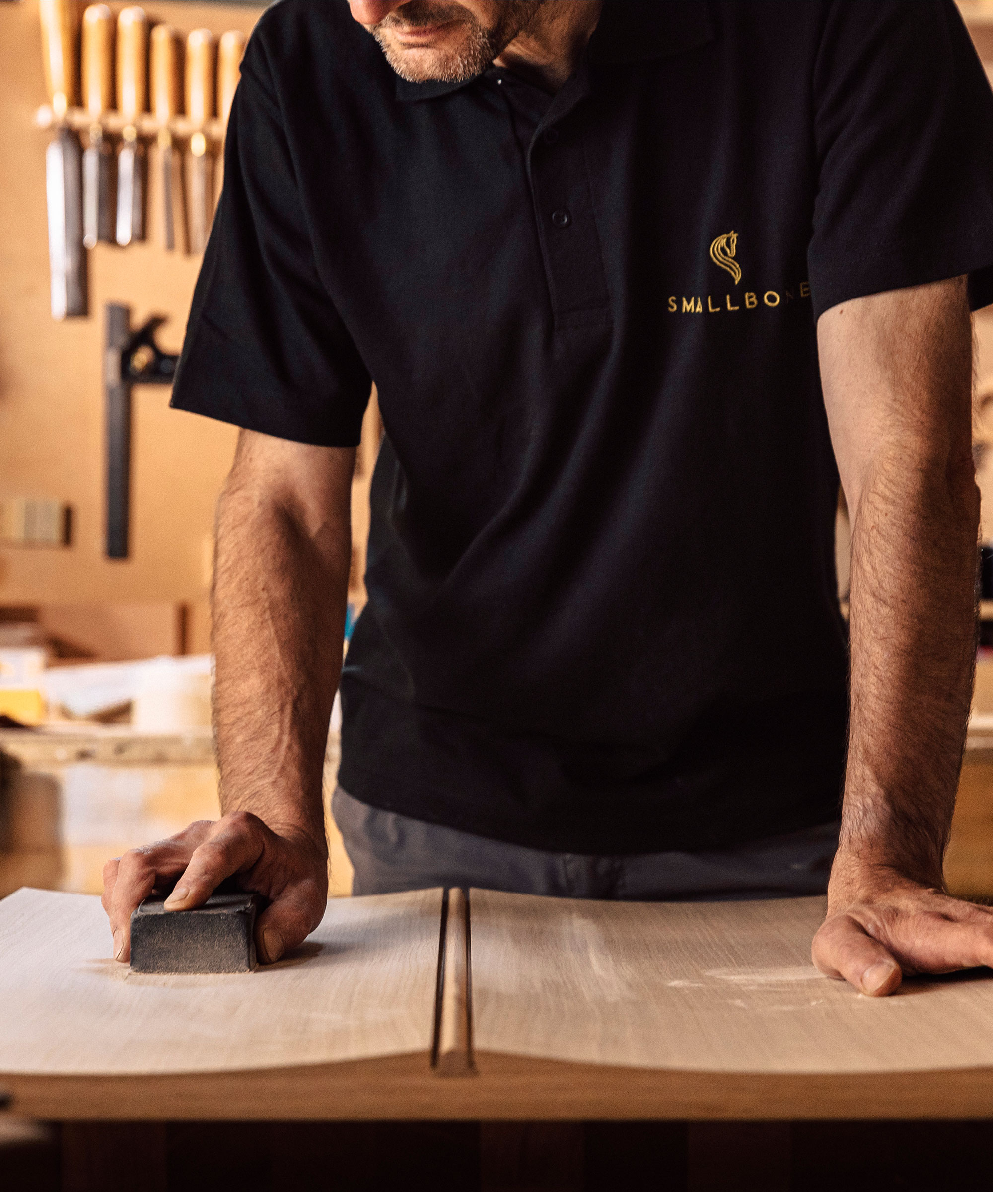 A Smallbone craftsman sanding an Icarus cabinet door front