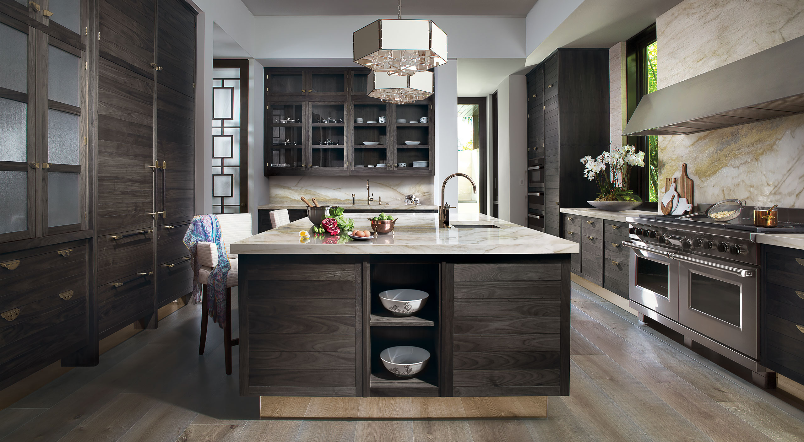 A Smallbone Napes collection kitchen withg grey stained oak cabinets and champange gold mirror plinths