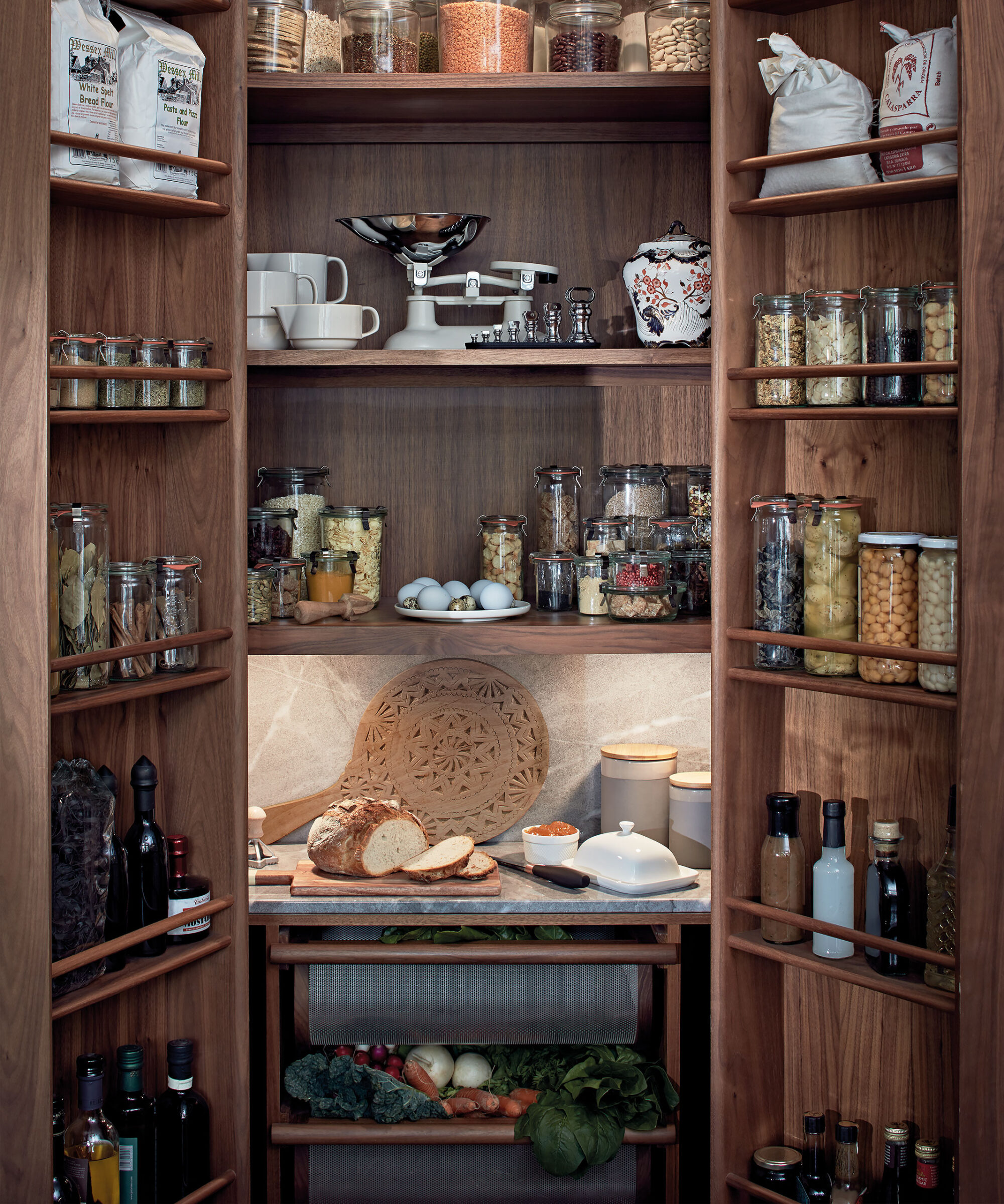 an open Smallbone larder with spice racks bottle racks and shelving