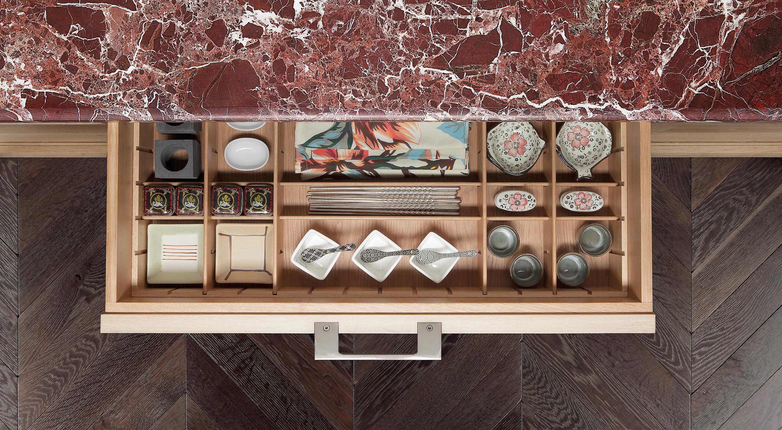 A Smallbone Brasserie kitchen island with limed oak cabinetry and Rosso Levanto marble worktop