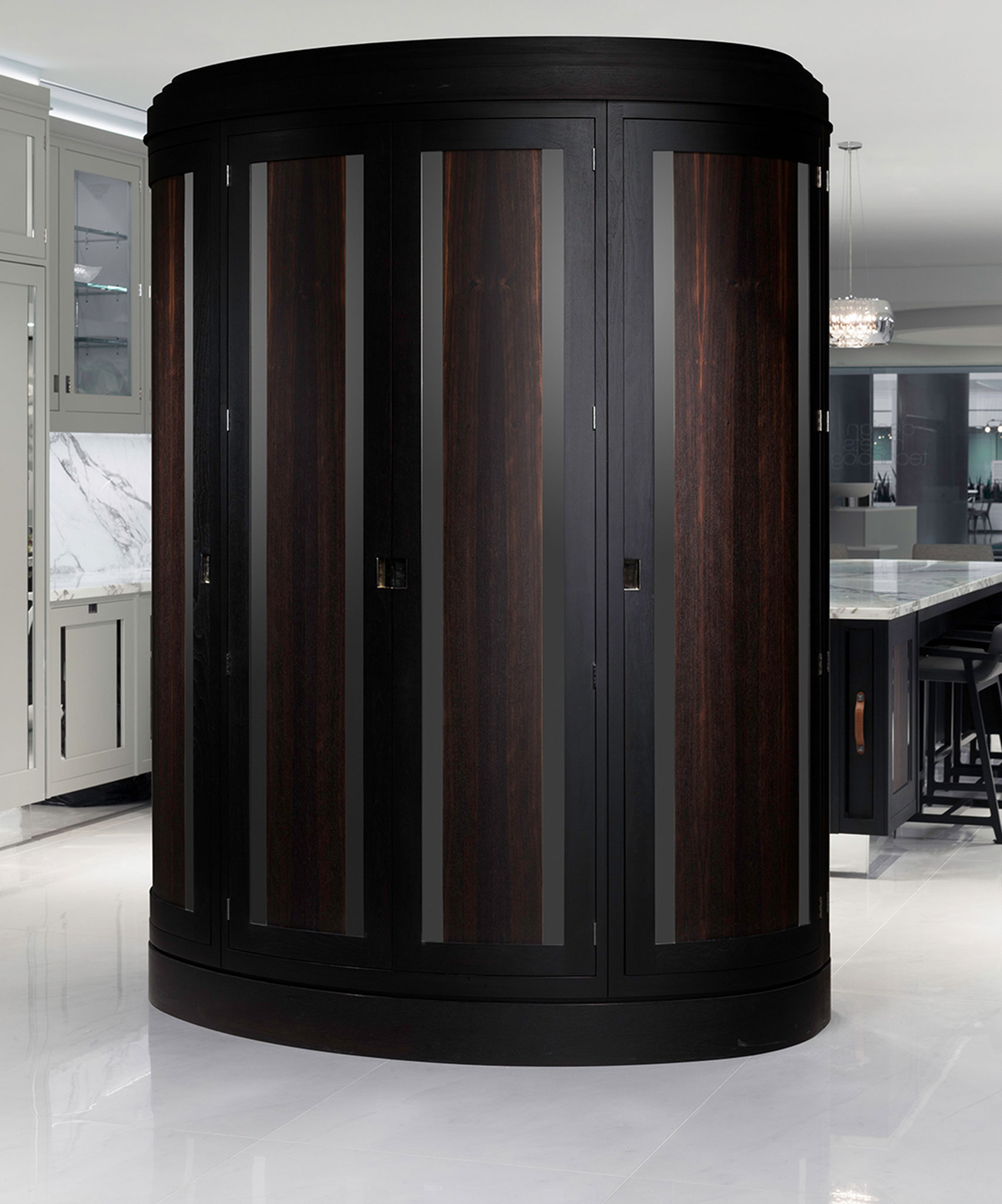 A curved Macassar Uber pantry by Smallbone with cabinet doors closed