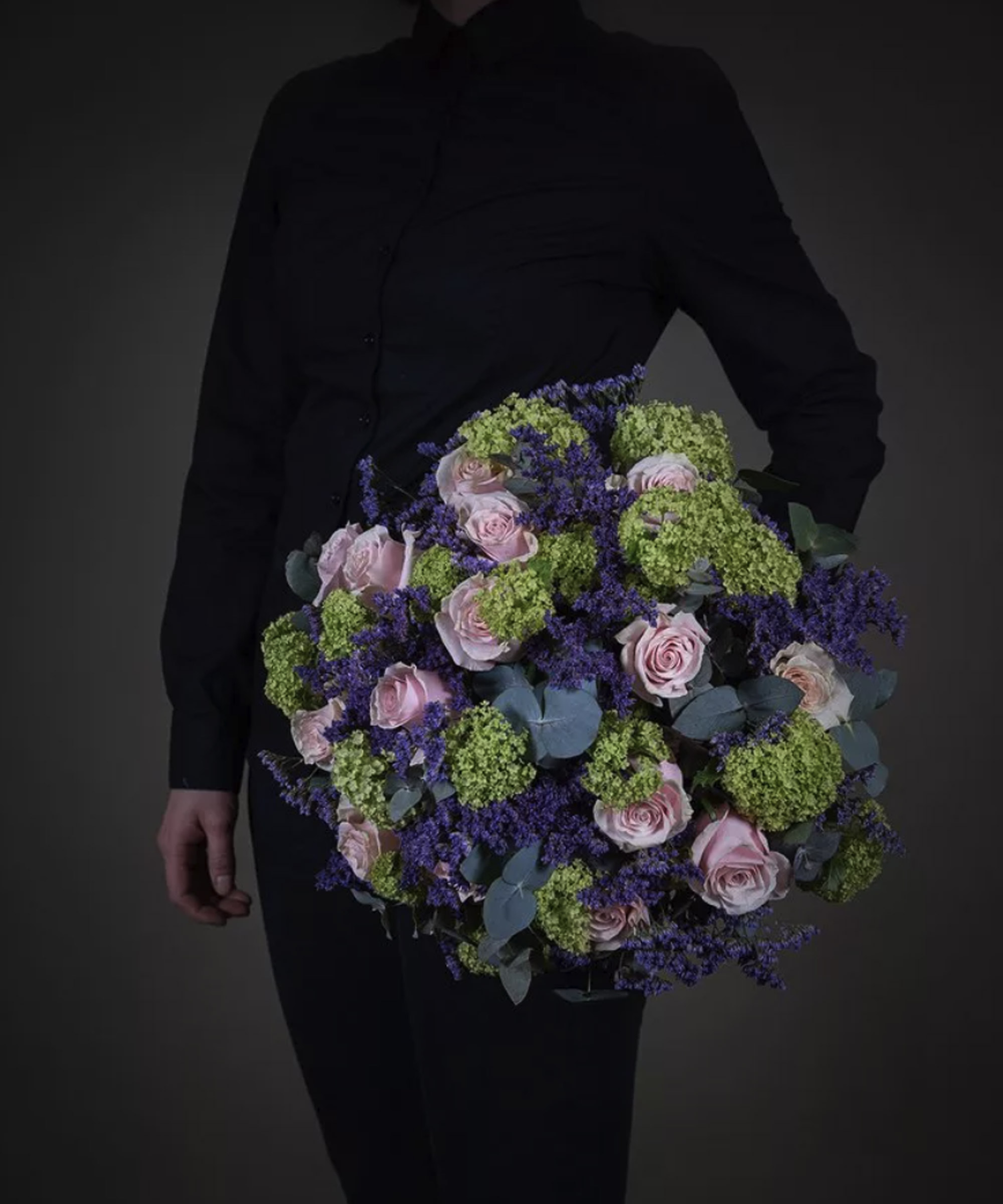 Mcqueens Flowers floral display being held by a model