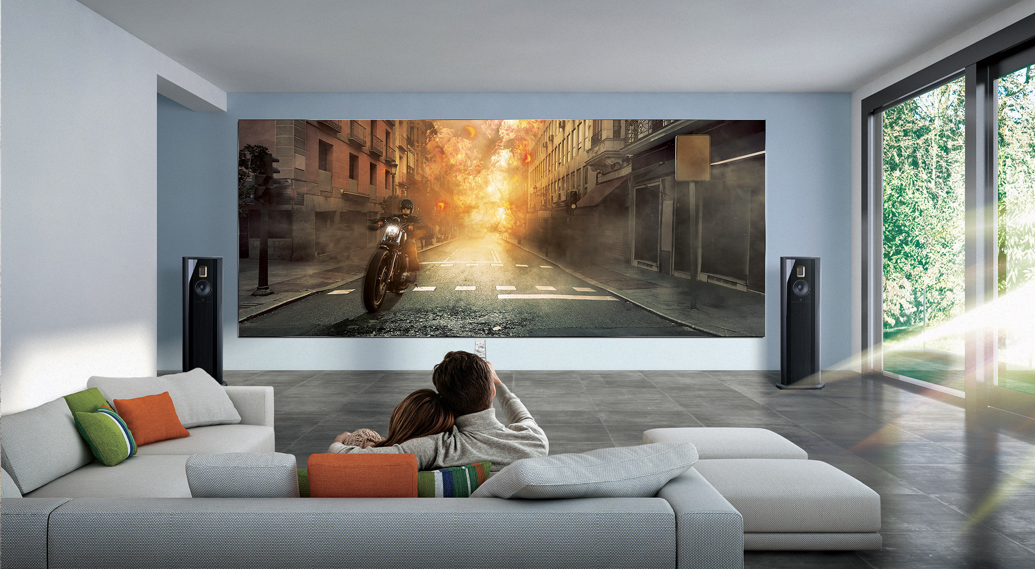 a couple at home watching a Samsung Wall television