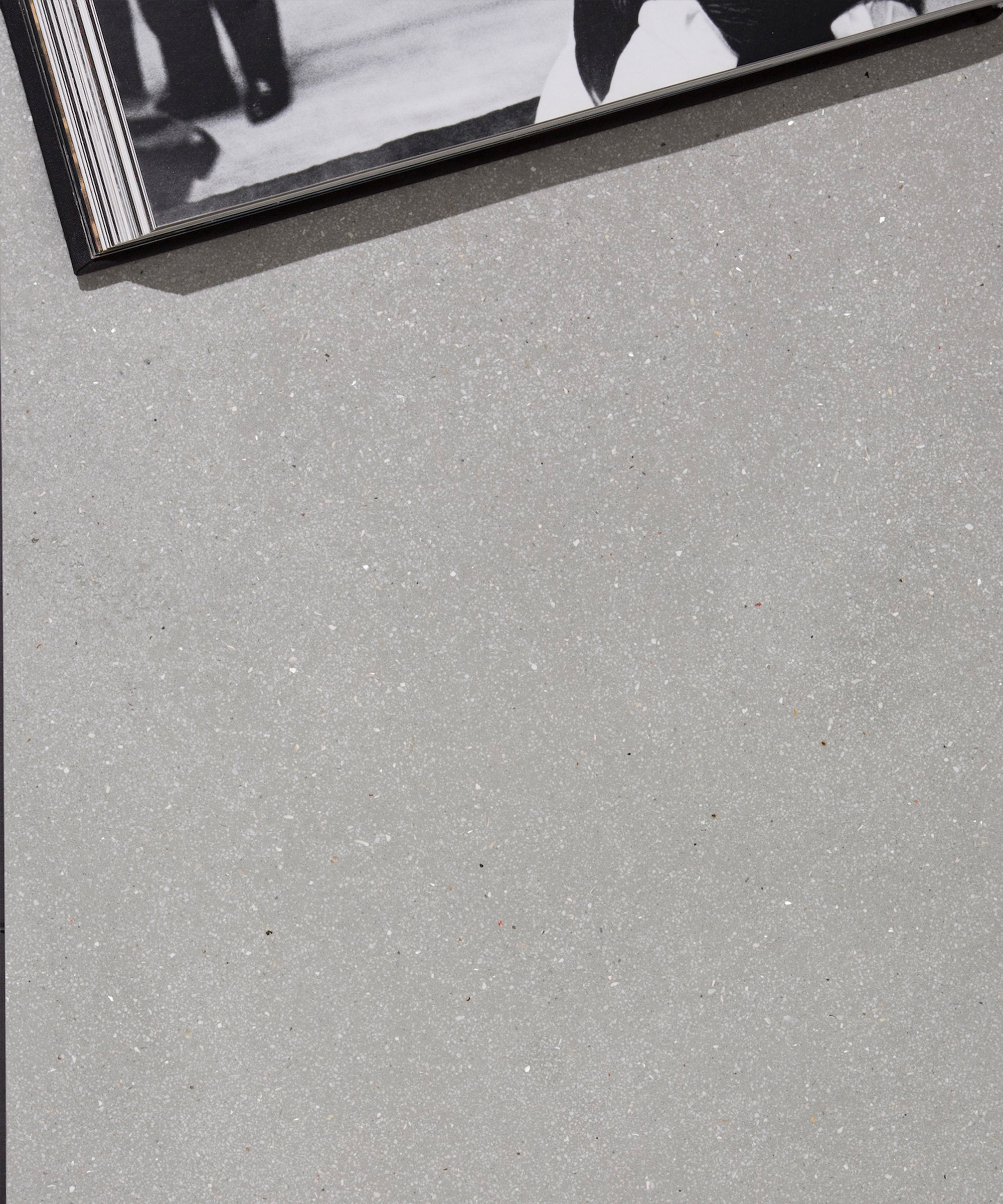 An open book laying on a light grey Senso floor