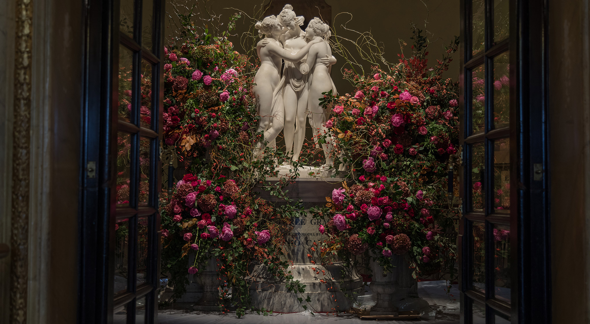 Mcqueens Flowers floral display with Greek statues