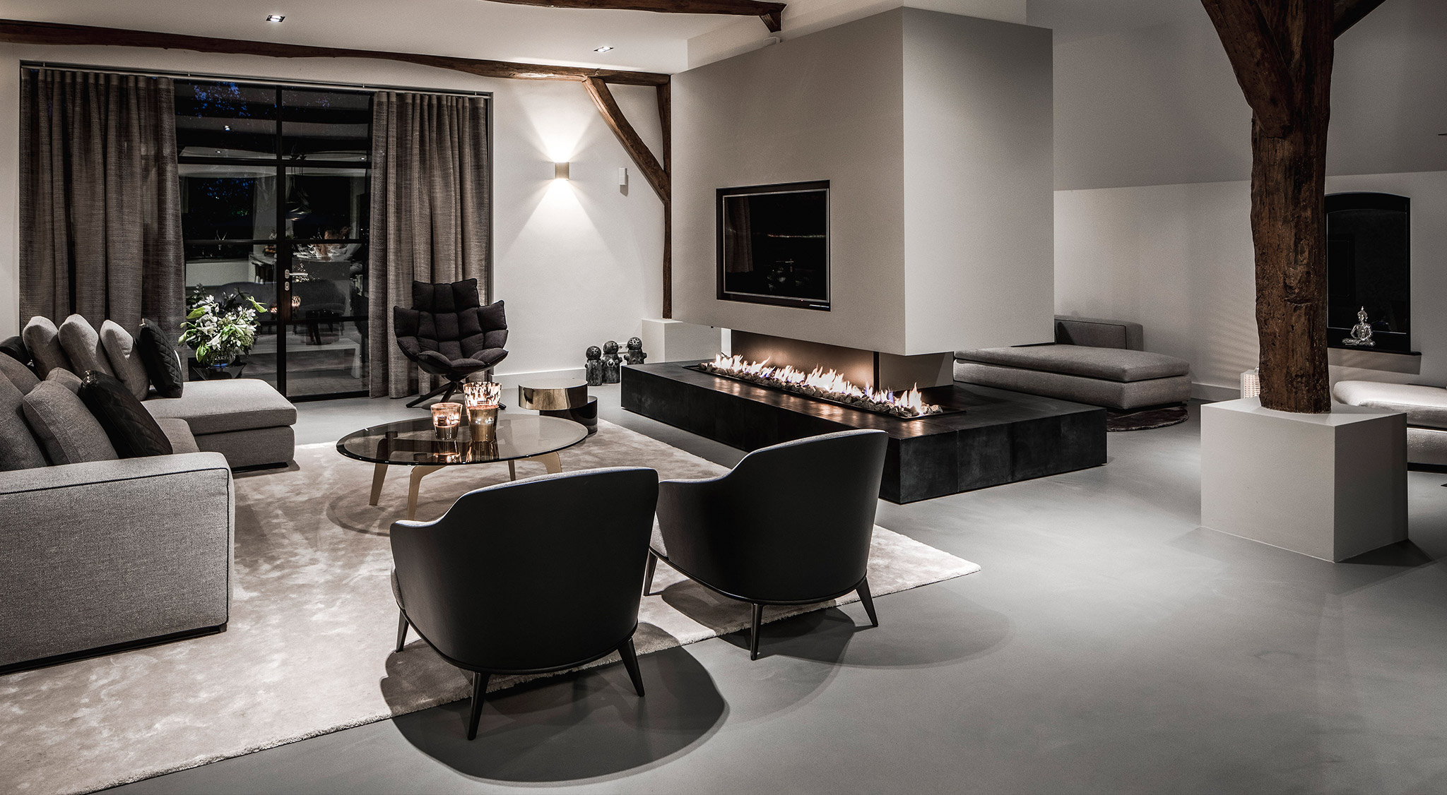 A sitting room with lit fireplace and a light grey Senso floor